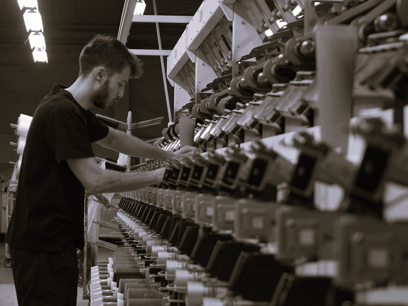 TRIVIALTEX employee monitoring the production process
